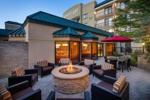 a patio with a fire pit in front of a hotel at Courtyard Cleveland Beachwood in Beachwood