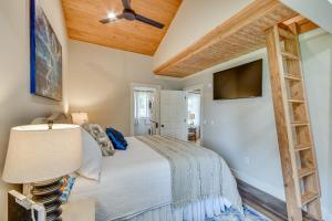 a bedroom with a bed and a ceiling fan at Lake Martin Retreat with Private Dock and Boat Launch in Dadeville