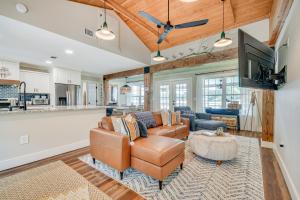 a living room with a couch and a tv at Lake Martin Retreat with Private Dock and Boat Launch in Dadeville