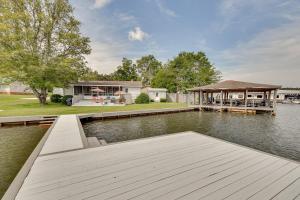 a house with a dock on the water at Lake Martin Retreat with Private Dock and Boat Launch in Dadeville