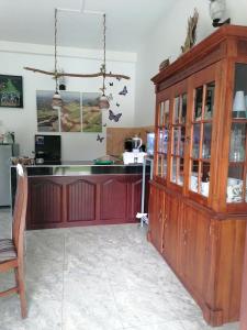 a kitchen with a counter and a wooden cabinet at Villa Riverplace in Beruwala