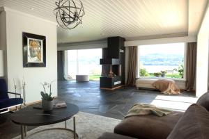 a living room with a dog laying on the floor at Villa Arboretet - Seaside villa with private pool & infrared sauna in the heart of Arboretet, Bergen in Bergen