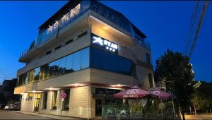 a building with two umbrellas in front of it at Star Hotel in Tulcea
