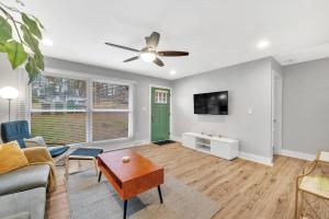 a living room with a couch and a ceiling fan at Homey 2BR Condo—King Bed—Lovely Location & Parking in Charlotte