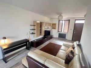 a living room with a couch and a television at Design Villa-Milano & Rho fiera in Sedriano