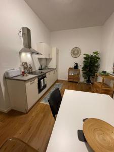 uma cozinha com um fogão e uma mesa num quarto em WEN BHF NEU & ZENTRAL in Weiden für bis zu 6 Personen em Weiden