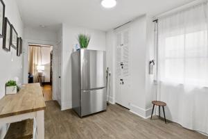 a kitchen with a stainless steel refrigerator and a table at King Bed-Full Kitchen-Self Check-In-Parking-UofR in Rochester