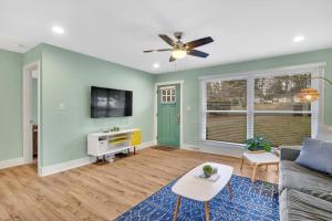 a living room with a couch and a ceiling fan at 2BR Condo~ Relax or Work Remotely with A+ Location in Charlotte