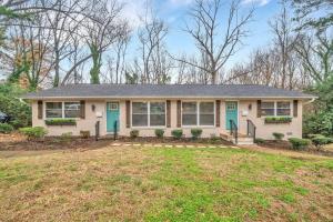 a white house with blue doors and a yard at 2BR Condo~ Relax or Work Remotely with A+ Location in Charlotte