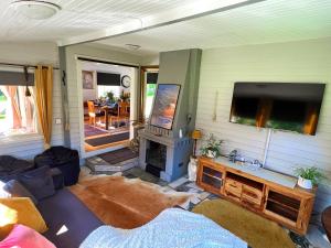 a living room with a flat screen tv and a fireplace at Lovely cottage by the south coast in Trelleborg