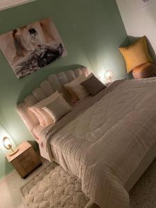 a bedroom with a large bed with two lamps at Faima in Douz