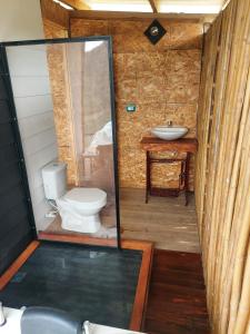 a bathroom with a toilet and a sink at COCOZNA Glamping in Norcasia