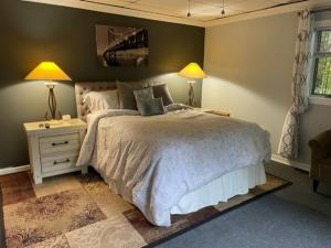 a bedroom with a bed and two lamps and a window at Heaven On Earth in Boone