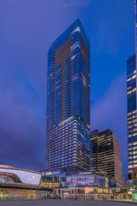 a tall skyscraper in a city at night at JW Marriott Edmonton ICE District in Edmonton