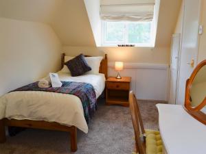 a small bedroom with a bed and a window at Ryndle Corner in Scarborough