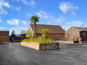 a parking lot with palm trees and a house at Baytree Lodge - Uk13322 in Melbourne