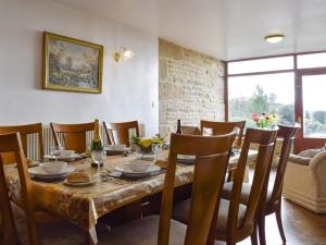 a dining room with a wooden table and chairs at High Gate - Uk30579 in Nelson