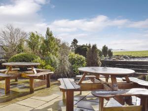 a group of picnic tables and benches on a patio at High Gate - Uk30579 in Nelson
