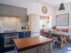 a kitchen with a table and a dining room at Tack Room in Benniworth