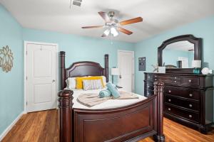 a bedroom with a bed and a ceiling fan at Serene Beachside Getaway - 77 Steps To The Ocean in Galveston