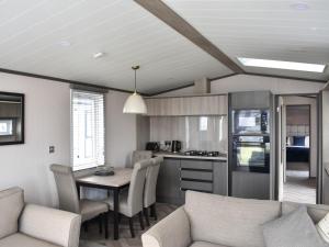 a kitchen and living room with a table and chairs at Marina Escape One in Peterhead