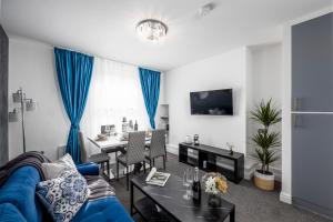 a living room with a blue couch and a table at Cosy 4-Bedroom Apartment next to Borough in London