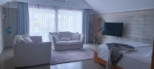 TV a/nebo společenská místnost v ubytování Bombua Beach House