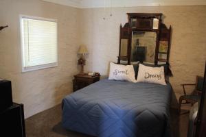 a bedroom with a bed with two pillows on it at Grand Canyon West Hotel Sheps Miners Inn in Chloride