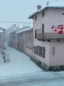 a city street covered in snow with a building at B&B San Gregorio in Cherasco