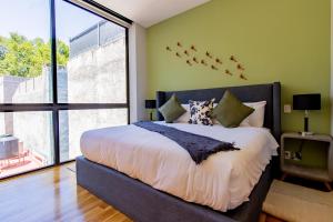 um quarto com uma cama grande com pássaros na parede em Capitalia - Luxury Apartments - Temístocles 40 em Cidade do México