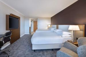 a hotel room with two beds and a flat screen tv at Delta Hotels by Marriott Bristol City Centre in Bristol