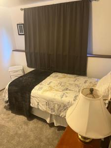 a bedroom with a bed and a table with a lamp at Anthony's Home in Spokane +16 photos