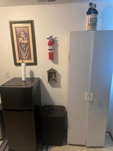 a room with a refrigerator and a trash can at Anthony's Home in Spokane