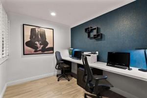 an office with a desk with a computer and two chairs at Best Western Plus Manhattan Beach Hotel in Manhattan Beach +26 photos
