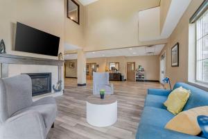 a living room with a couch and a fireplace at Comfort Suites Lake Geneva East in Lake Geneva