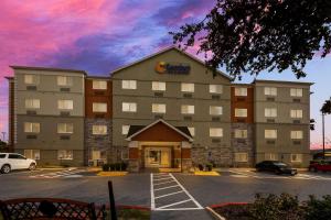 a rendering of the front of a hotel with a parking lot at Comfort Inn & Suites in Austin
