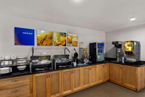a kitchen with a counter top with a coffee machine at Comfort Inn & Suites in Austin