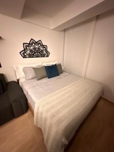a bedroom with a large white bed in a room at Apartaloft La Candelaria Downtown Bogota in Bogotá