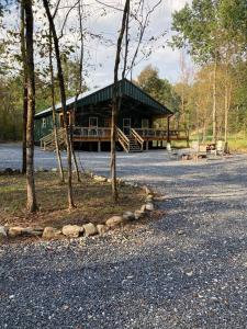 a cabin in the middle of a road with trees at Livin on the Edge Cabin in Albert Pike, Beautiful! in Caddo Gap
