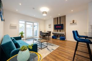 a living room with a blue couch and a table at Stunning 2 Bedroom Apartment in Chorlton in Manchester