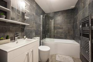 a bathroom with a white toilet and a sink at Stunning 2 Bedroom Apartment in Chorlton in Manchester