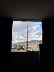 a window in a room with a view of a city at Hostal Colonial in Cajamarca
