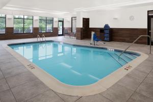 a large pool with blue water in a building at Fairfield by Marriott Inn & Suites Whitsett Greensboro East in Whitsett