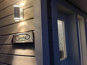 a santa sign on the door of a house at Luxurious Villa Kinos with Jacuzzi in Rovaniemi