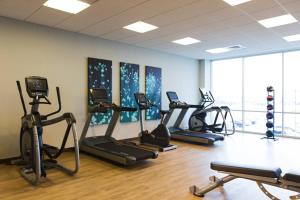 a gym with several treadmills and exercise bikes at AC Hotel Cincinnati at Liberty Center in West Chester