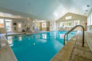 a large swimming pool with a slide in a building at Residence Inn by Marriott Woodbridge Edison/Raritan Center in Woodbridge