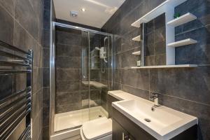 a bathroom with a sink and a shower and a toilet at Luxury 2 Bedroom Apartment In Chorlton in Manchester