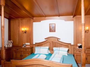 a bedroom with a wooden bed with two pillows at Adlerhorst , Gstan 31 in Finkenberg