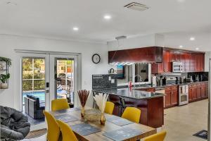 a kitchen with a table and yellow chairs in it at Vacation Villa W Heated Pool Beach & Casino in Hollywood