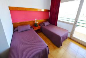 Posteľ alebo postele v izbe v ubytovaní Hostal Magnolia